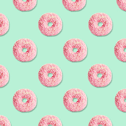 Image of Creative pattern design of glazed donuts on light turquoise background