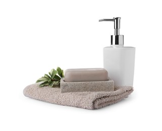 Dish with soap bar, dispenser and terry towel on white background