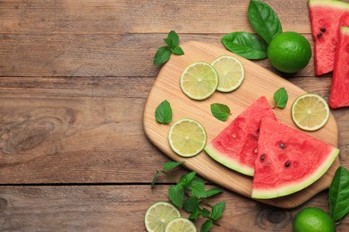 Tasty sliced watermelon and limes on wooden table, flat lay. Space for text
