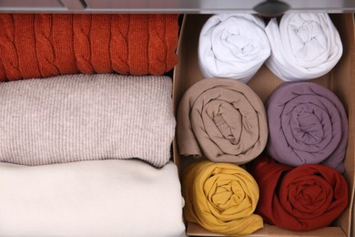 Different folded clothes as background, top view. Vertical storage