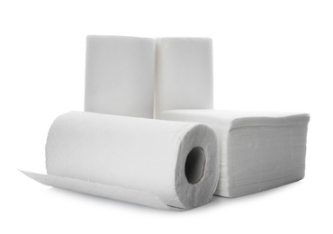 Rolls and stack of clean paper tissues on white background