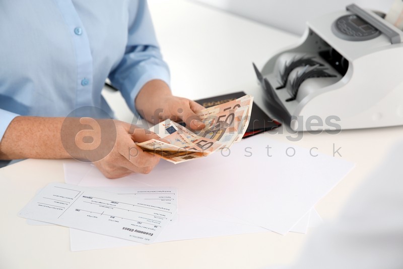 Female teller with money at cash department
