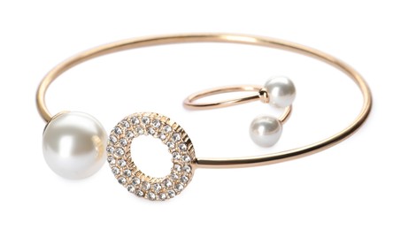 Elegant golden bracelet and ring with pearls on white background