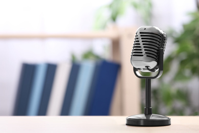 Retro microphone on table indoors, space for text. Interview