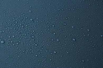 Many water drops on dark dusty blue background