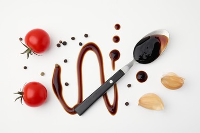 Photo of Organic balsamic vinegar and cooking ingredients on white background, flat lay