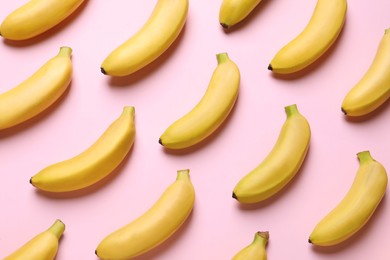 Sweet ripe baby bananas on light pink background, flat lay