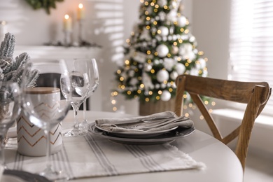Festive table setting and beautiful Christmas decor indoors. Interior design