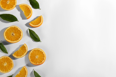 Slices of delicious oranges on white background, flat lay. Space for text