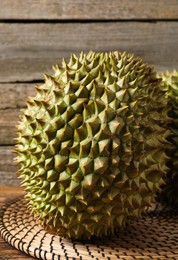 Ripe durians on wooden table, closeup view