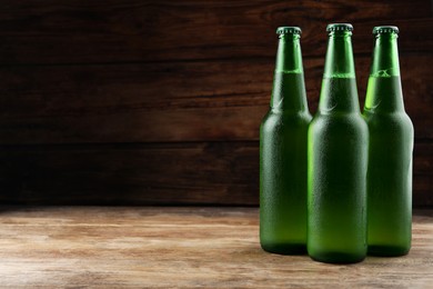 Photo of Many bottles of beer on wooden table, space for text