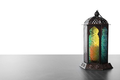 Decorative Arabic lantern on grey table against white background