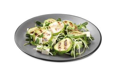 Delicious salad with grilled zucchini slices and feta cheese on white background