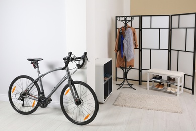 Modern apartment interior with bicycle near wall