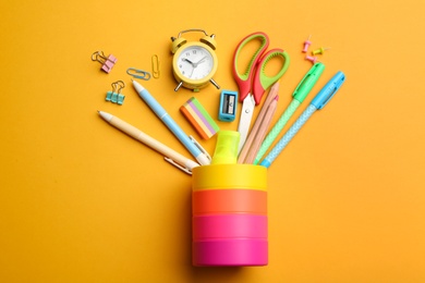 Flat lay composition with school stationery on orange background. Back to school