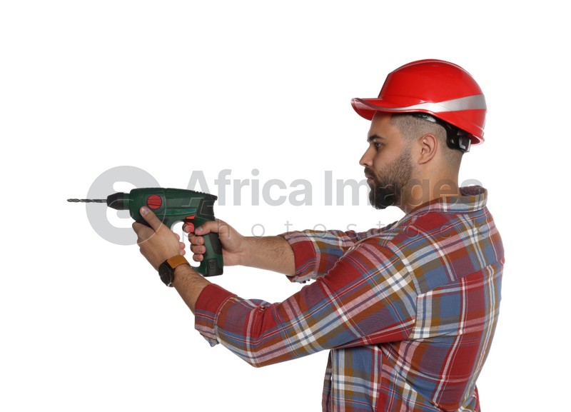 Young worker in hard hat with power drill on white background