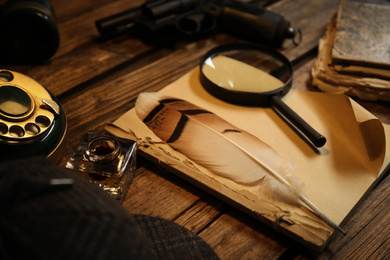 Composition with vintage detective items on wooden table, closeup