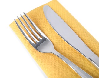 Yellow napkin with fork and knife on white background, closeup