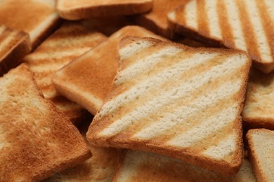 Slices of tasty toasted bread as background, closeup