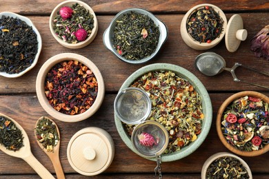 Many different herbal teas on wooden table, flat lay