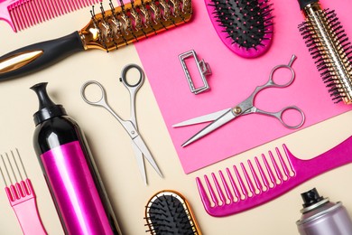 Flat lay composition of professional scissors and other hairdresser's equipment on color background. Haircut tool