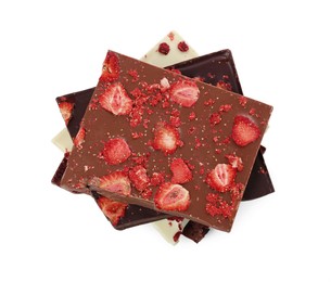 Photo of Chocolate bars with freeze dried strawberries on white background, top view