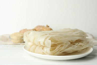 Photo of Raw rice noodles on white wooden table