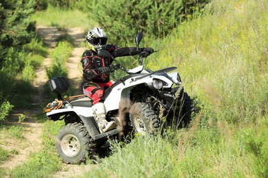 Man performing trick with modern quad bike outdoors. Extreme sport