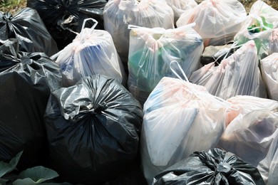 Many trash bags full of garbage outdoors, closeup. Environmental Pollution concept