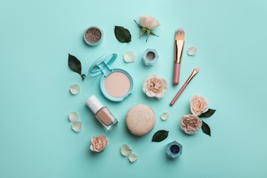 Flat lay composition with makeup products, roses and macaron on turquoise background