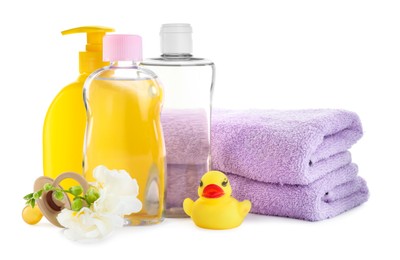 Photo of Baby oil, toiletries, flowers and toy duck on white background