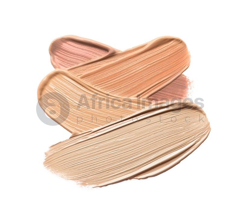 Different shades of liquid foundation on white background, top view