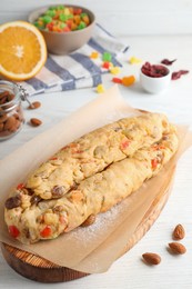 Unbaked Stollen with candied fruits and raisins on white wooden table