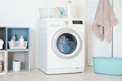 Washing of different towels in modern laundry room