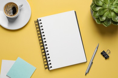 Photo of Flat lay composition with stylish notebook on yellow background