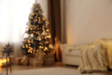 Beautiful living room interior with decorated Christmas tree and gifts, blurred view