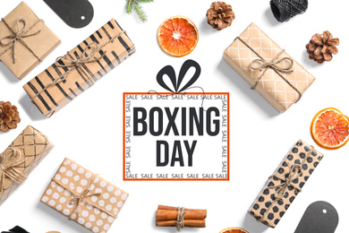 Flat lay composition with gifts and text Boxing Day on white background