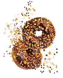 Sweet delicious donuts falling on white background