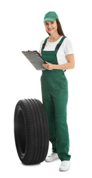 Photo of Professional auto mechanic with tire and clipboard on white background
