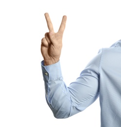 Young man showing victory gesture on white background