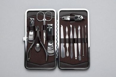 Photo of Manicure set in case on grey background, top view