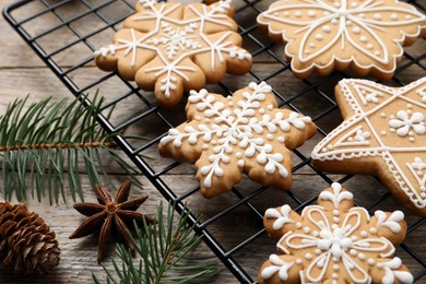 Tasty Christmas cookies, fir branches, cone and anise on wooden table, closeup