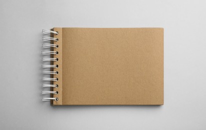 Notebook with brown paper pages on white background, top view