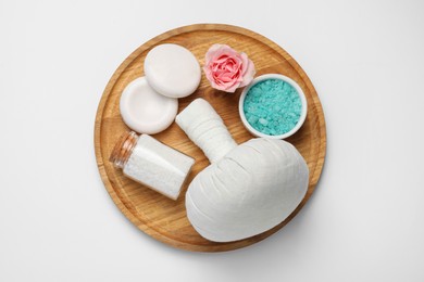 Beautiful spa composition with herbal massage bag and different care products on white background, top view
