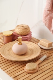 Different toiletries on wooden countertop in bathroom