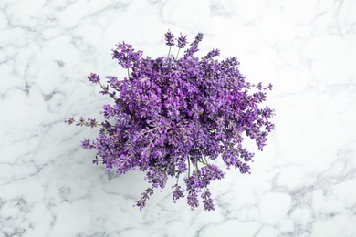 Photo of Beautiful lavender bouquet on white marble table, top view
