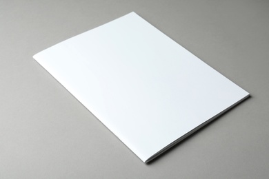 Brochure with blank cover on grey background. Mock up for design