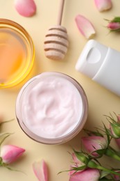 Photo of Different hand care cosmetic products, honey and roses on beige background, flat lay