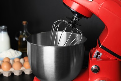 Photo of Modern stand mixer in kitchen, closeup. Home appliance