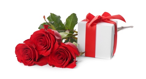 Beautiful red roses and gift box on white background. St. Valentine's day celebration
